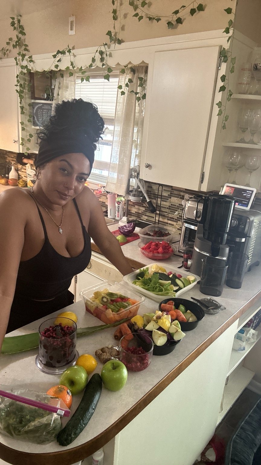 Brittney J with fresh produce in her kitchen