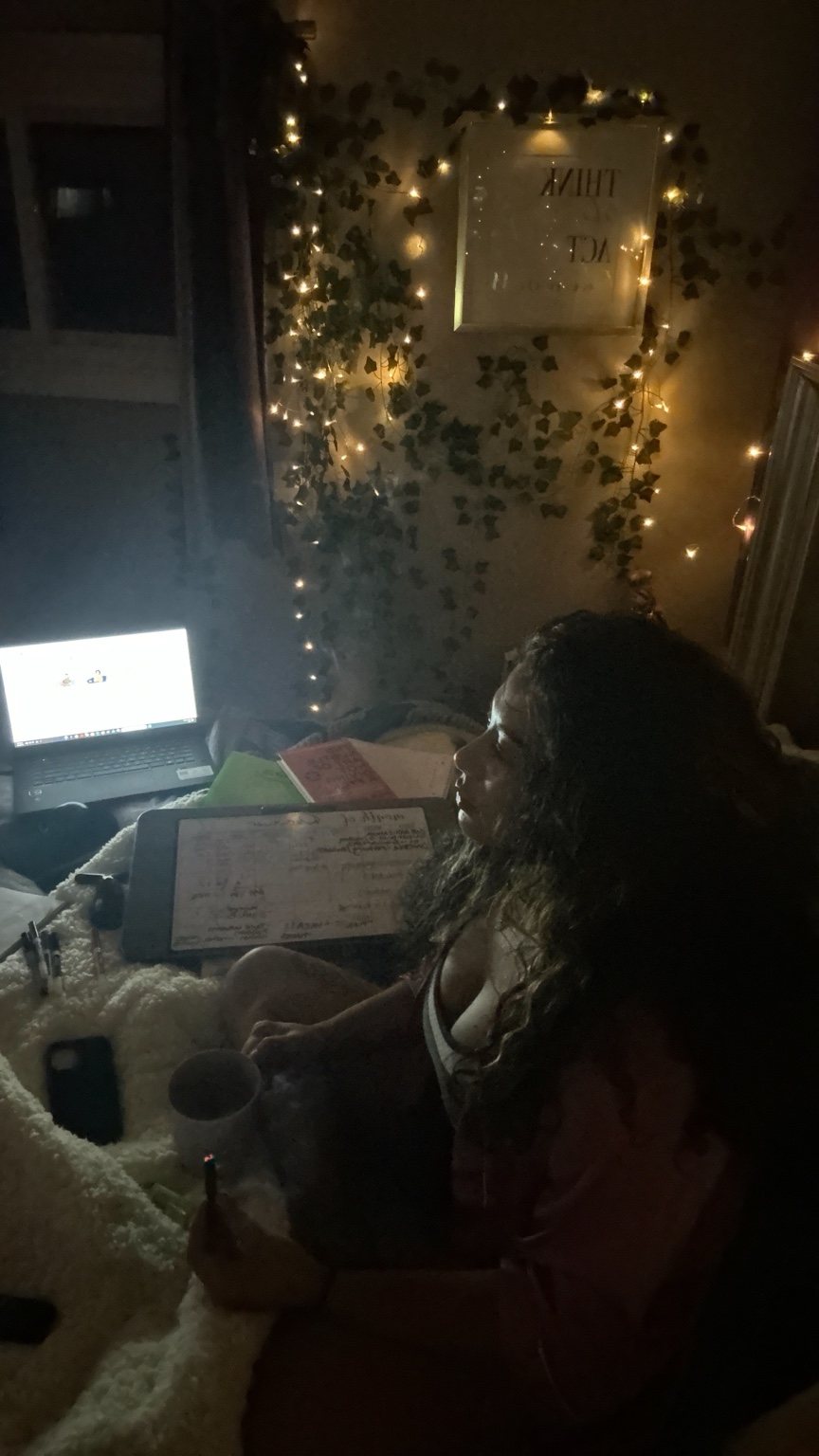 Brittney J working at home in her room with lights in the background